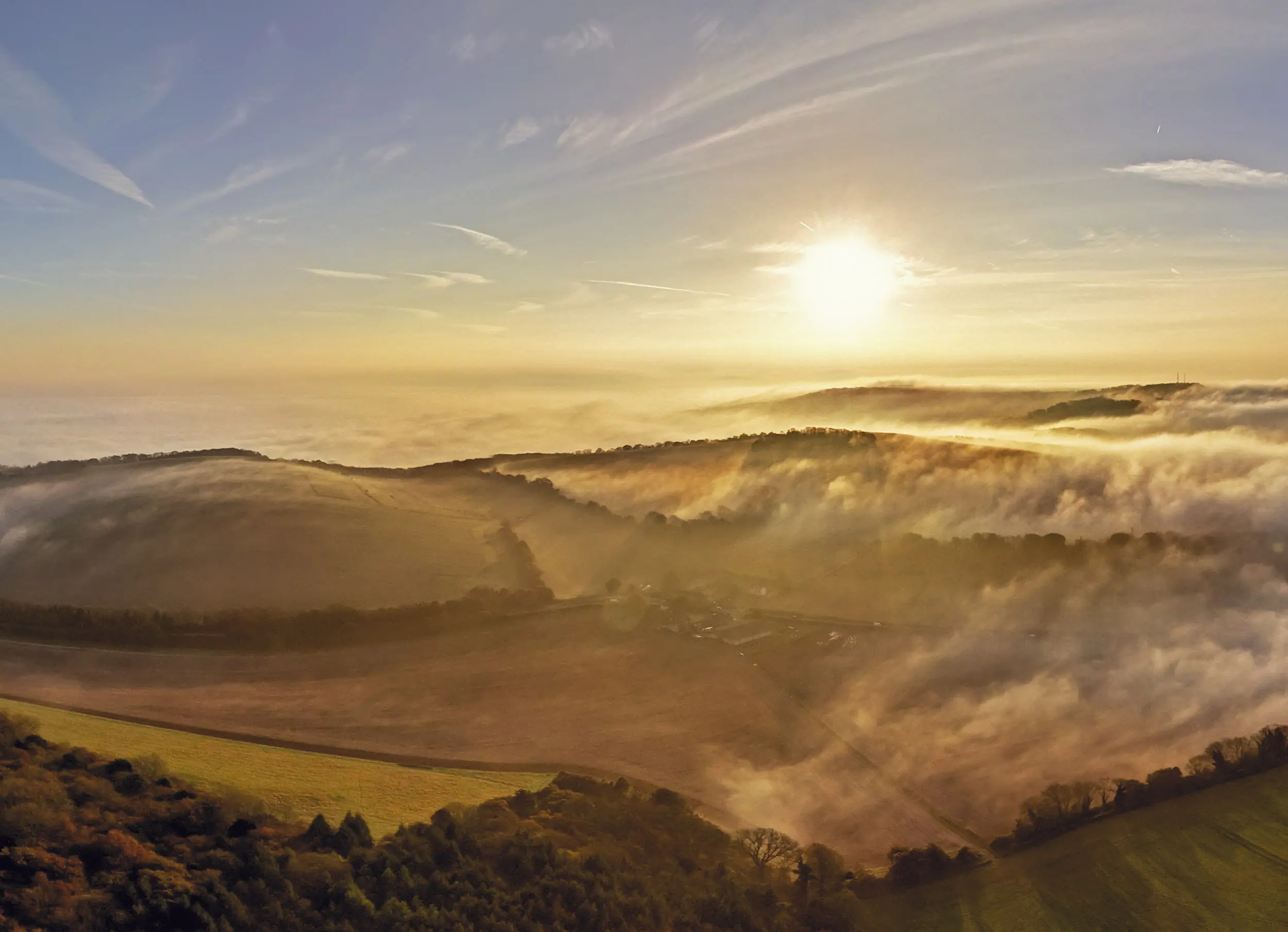 Sunrise through the mist over East Lavington, in the West Sussex Downs
